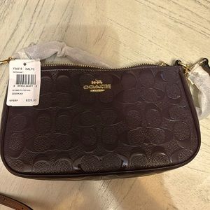 Coach oxblood colored handbag no rips or tears, brand new with tags